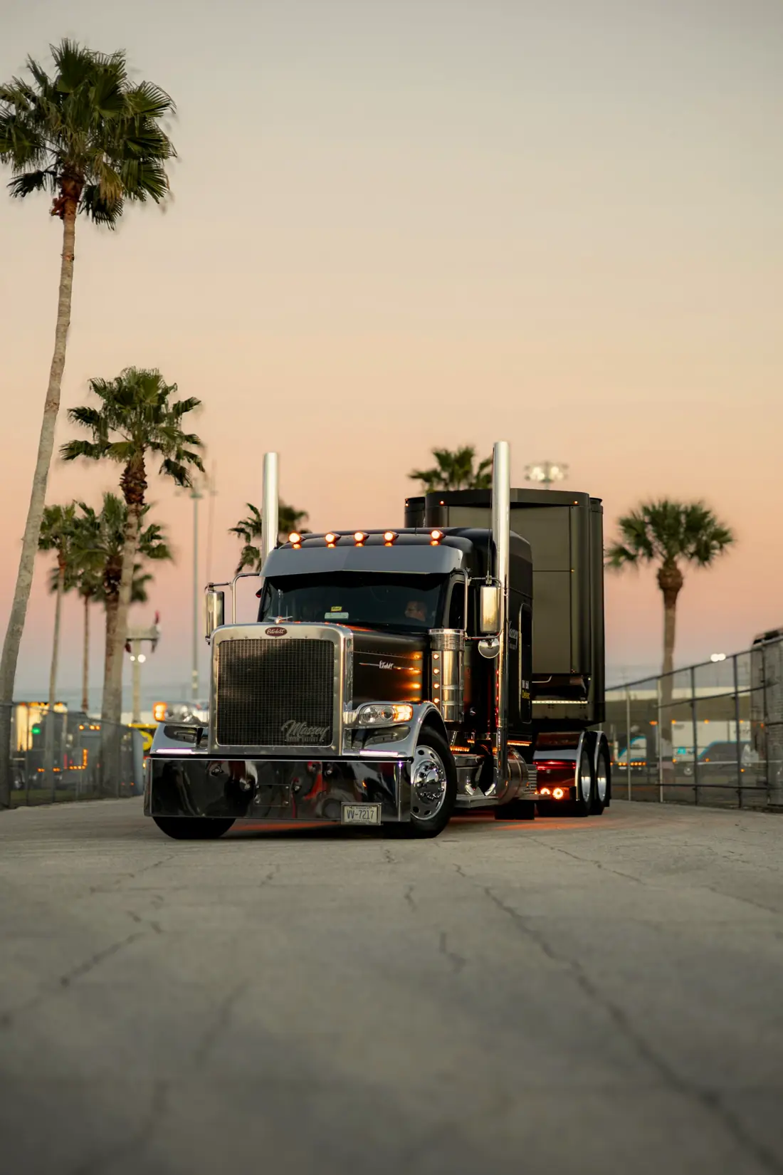 Black chrome Peterbilt semi-truck at sunset